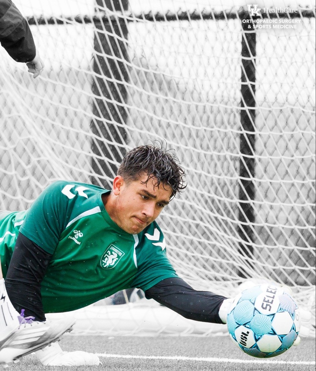 Garrett Addams making a save, in colour against black and white